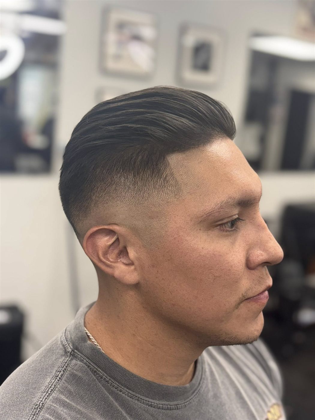 Finished haircut with a clean fade and sharp shape